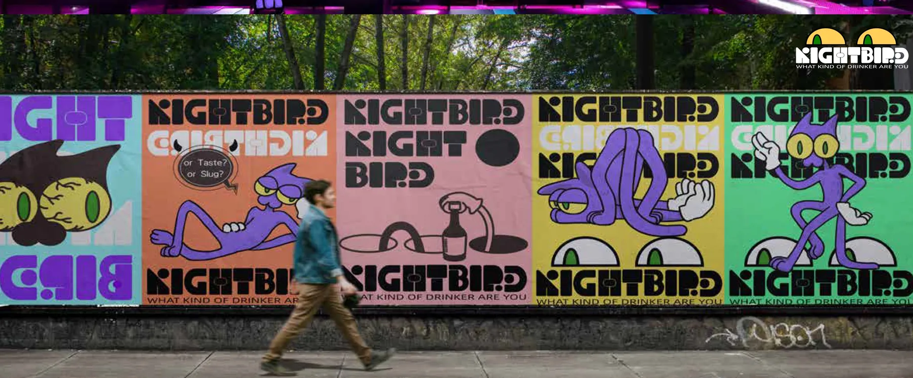 街边围墙上连排张贴的五张 NIGHTBIRD 海报，行人走过
